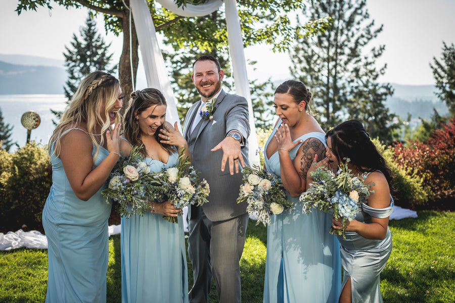 Light blue wedding theme with white roses, blue and greenery bouquets from Daisies in May