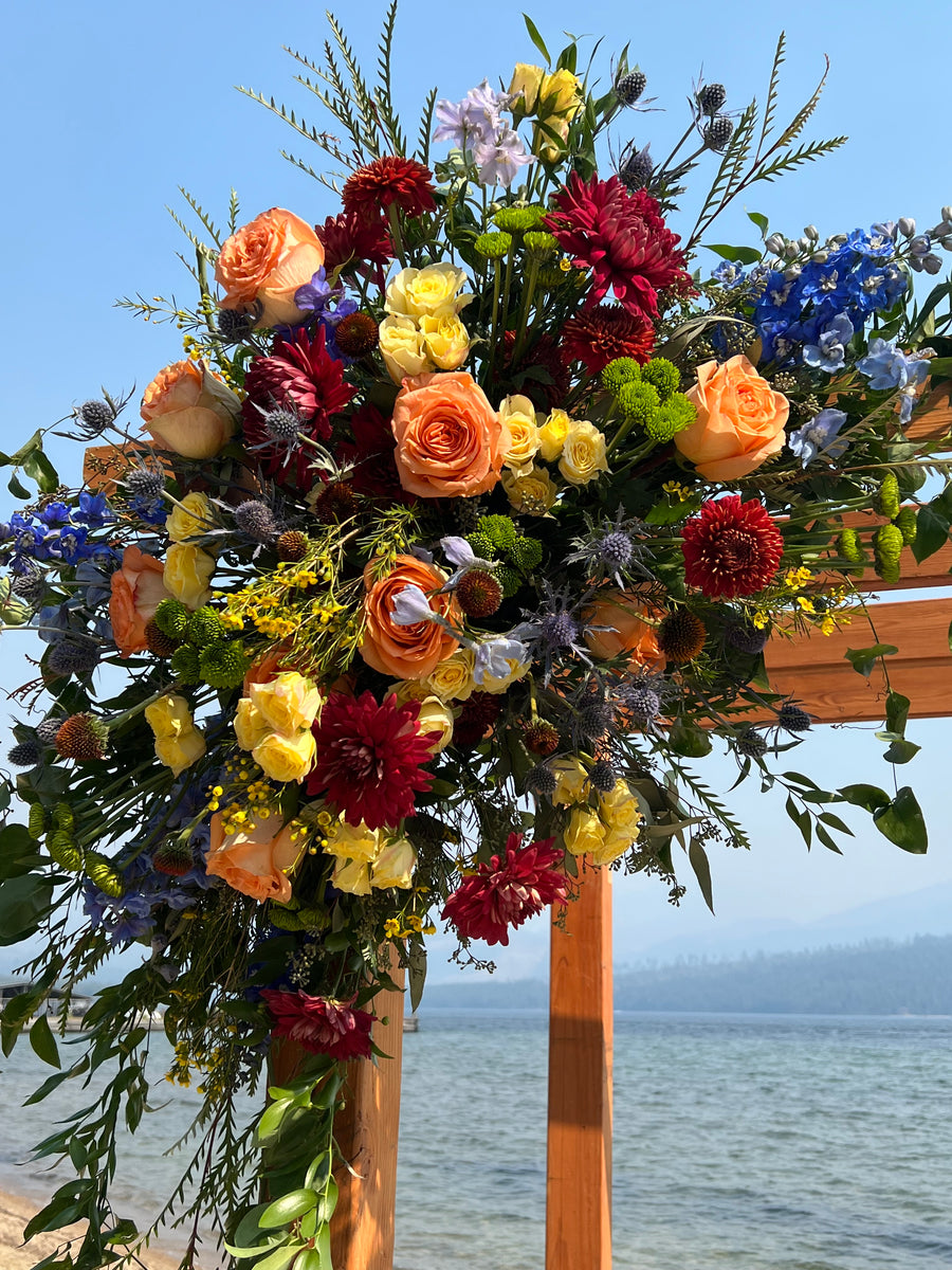 Wildflowers in shades of autumn for a gorgeous arbor arrangement
