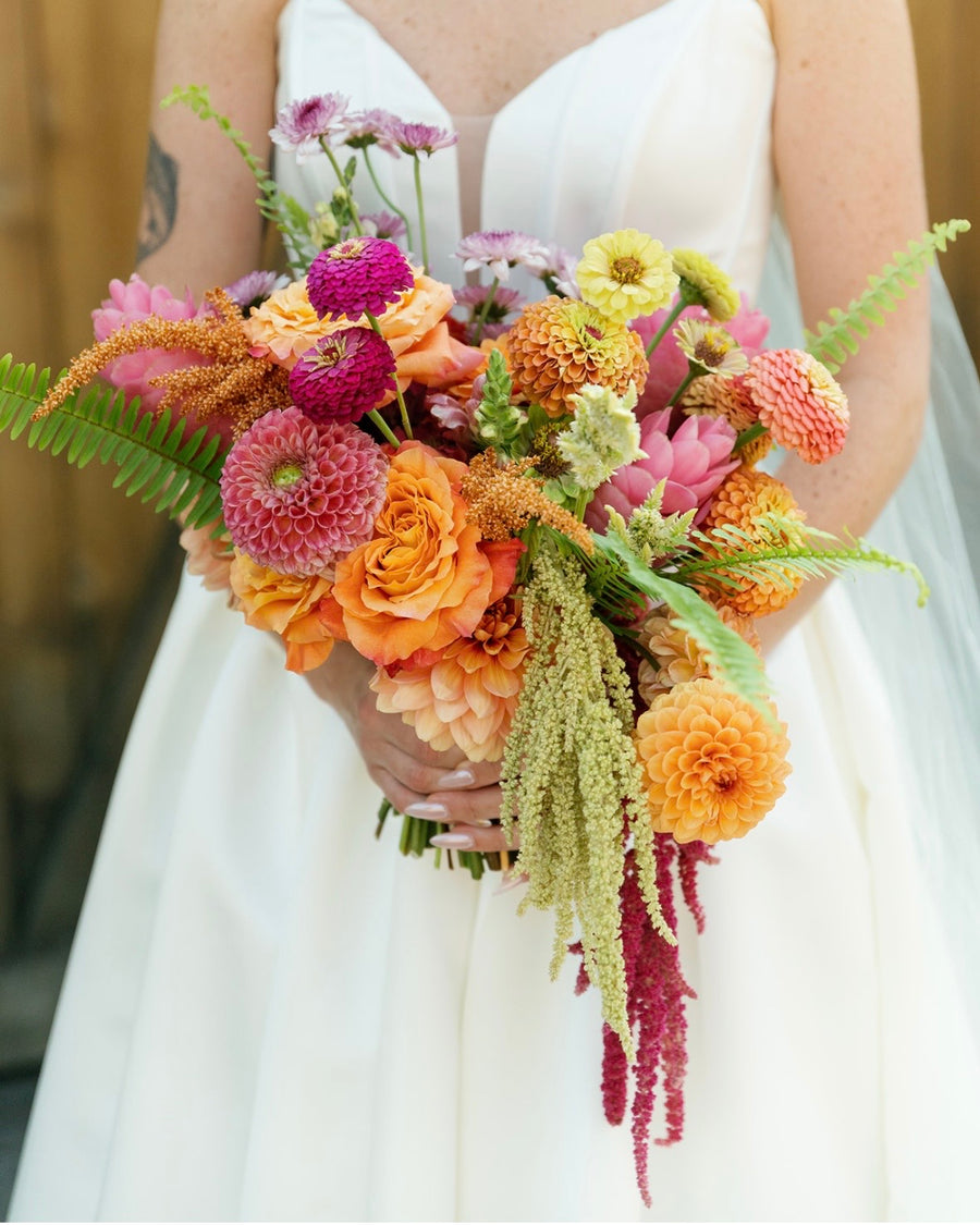 Citrus, pink and magenta bridal bouquet arrangement by Spokane wedding florist, Daisies in May