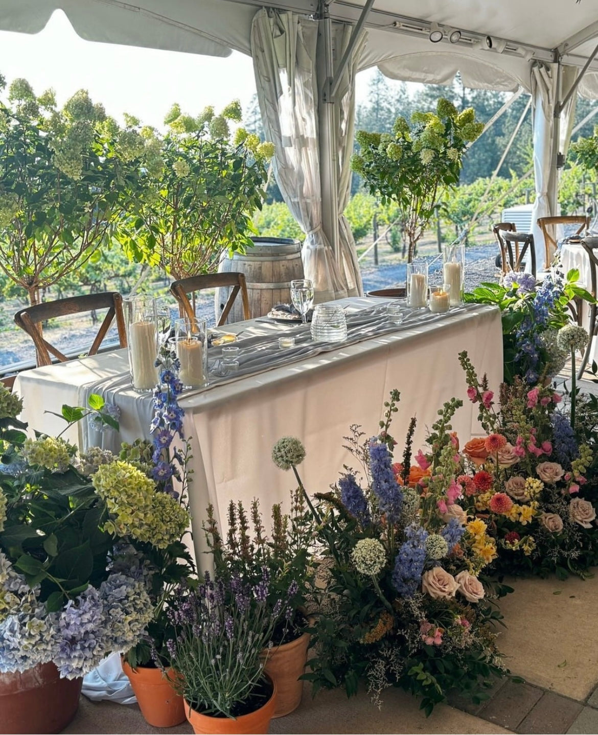 Sweetheart table dripping with wildflowers and hydrangeas by Daisies in May