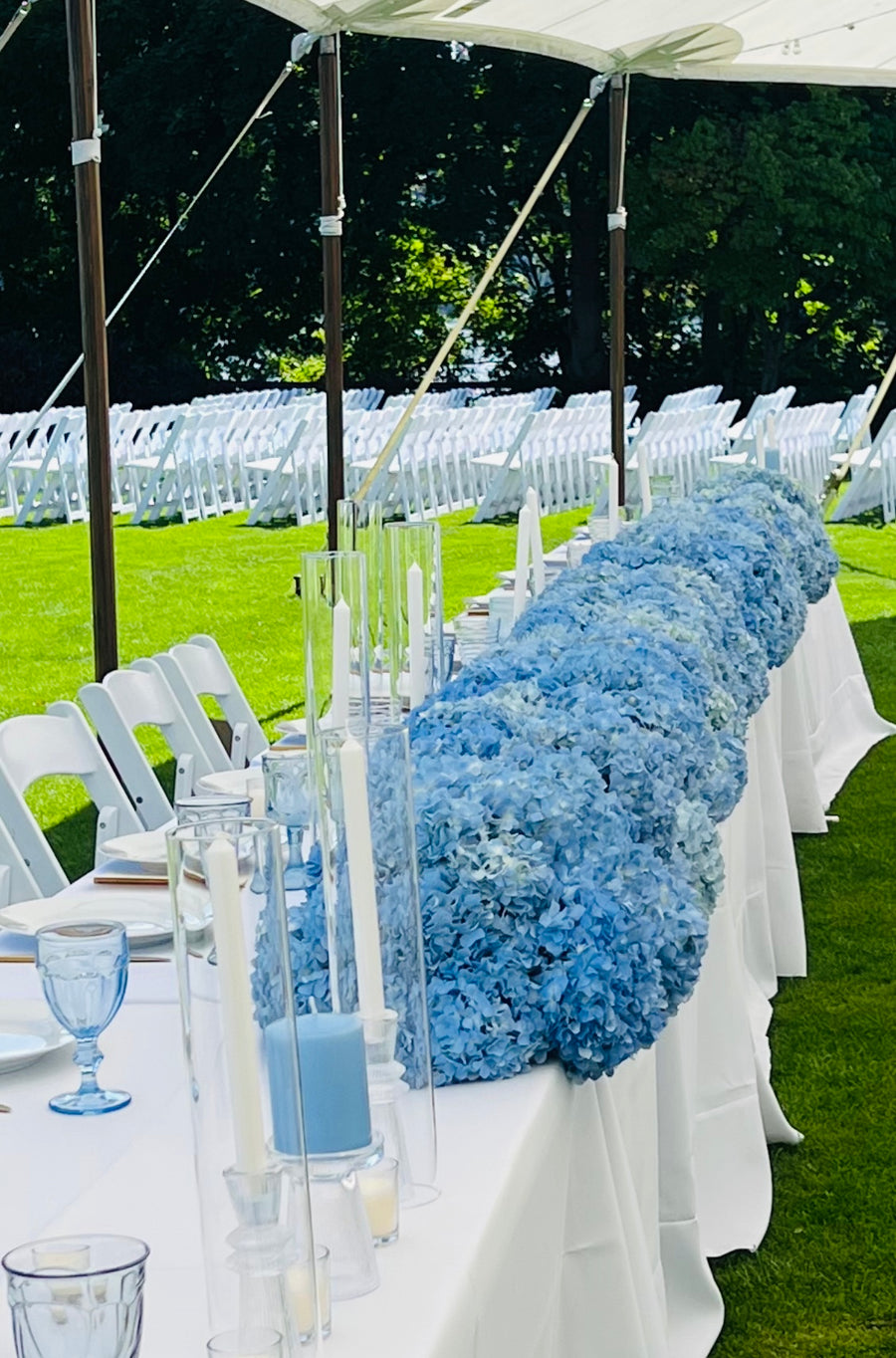 Blue Hydrangea table centerpieces at a beautiful outdoor wedding reception in Spokane, WA