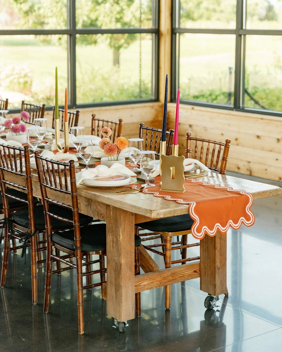 Wedding reception for a rustic fall wedding theme. Table is filled with tapered candles and floral accents.