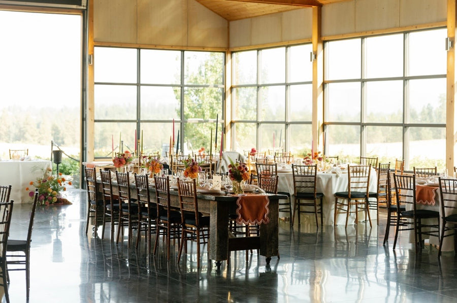 Reception tables with floral arrangements by Daisies in May