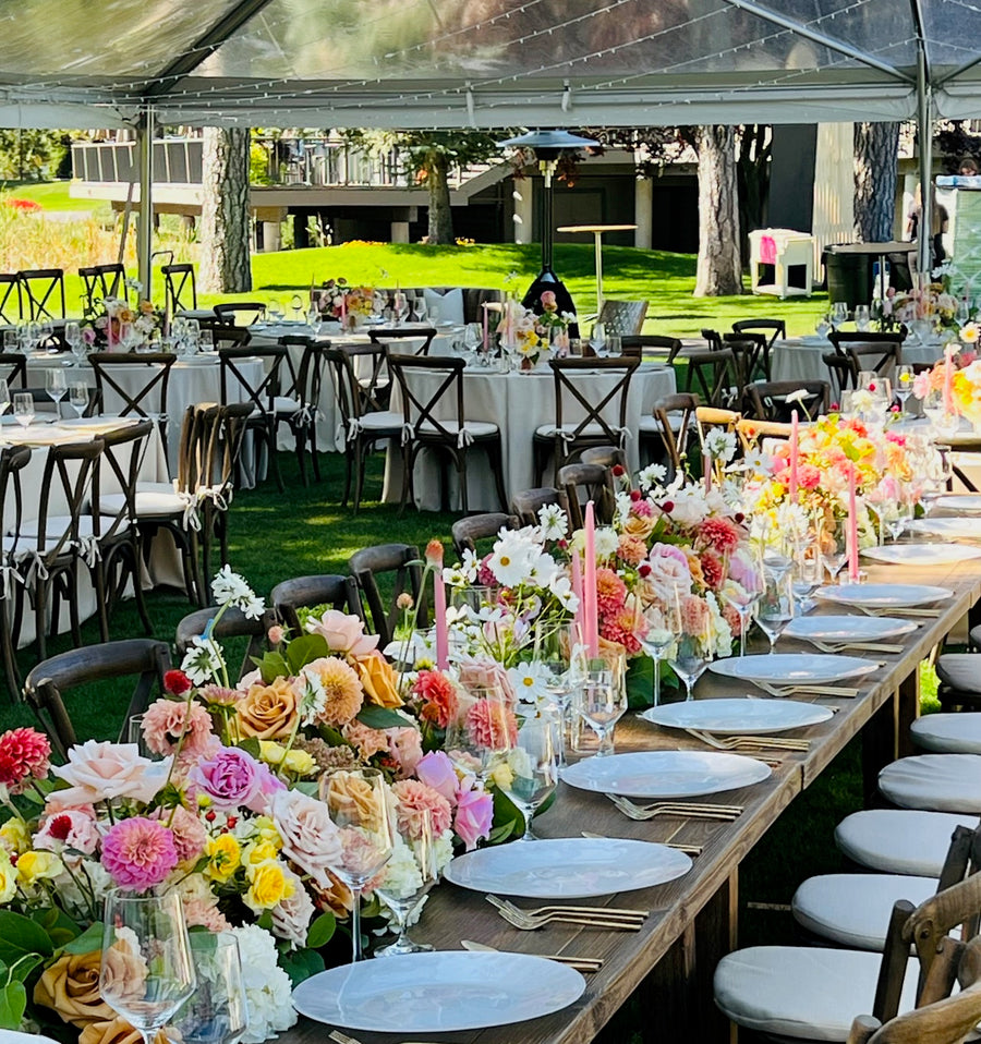 Beautiful summery citrus flower centerpieces for an outdoor wedding reception in Spokane, WA