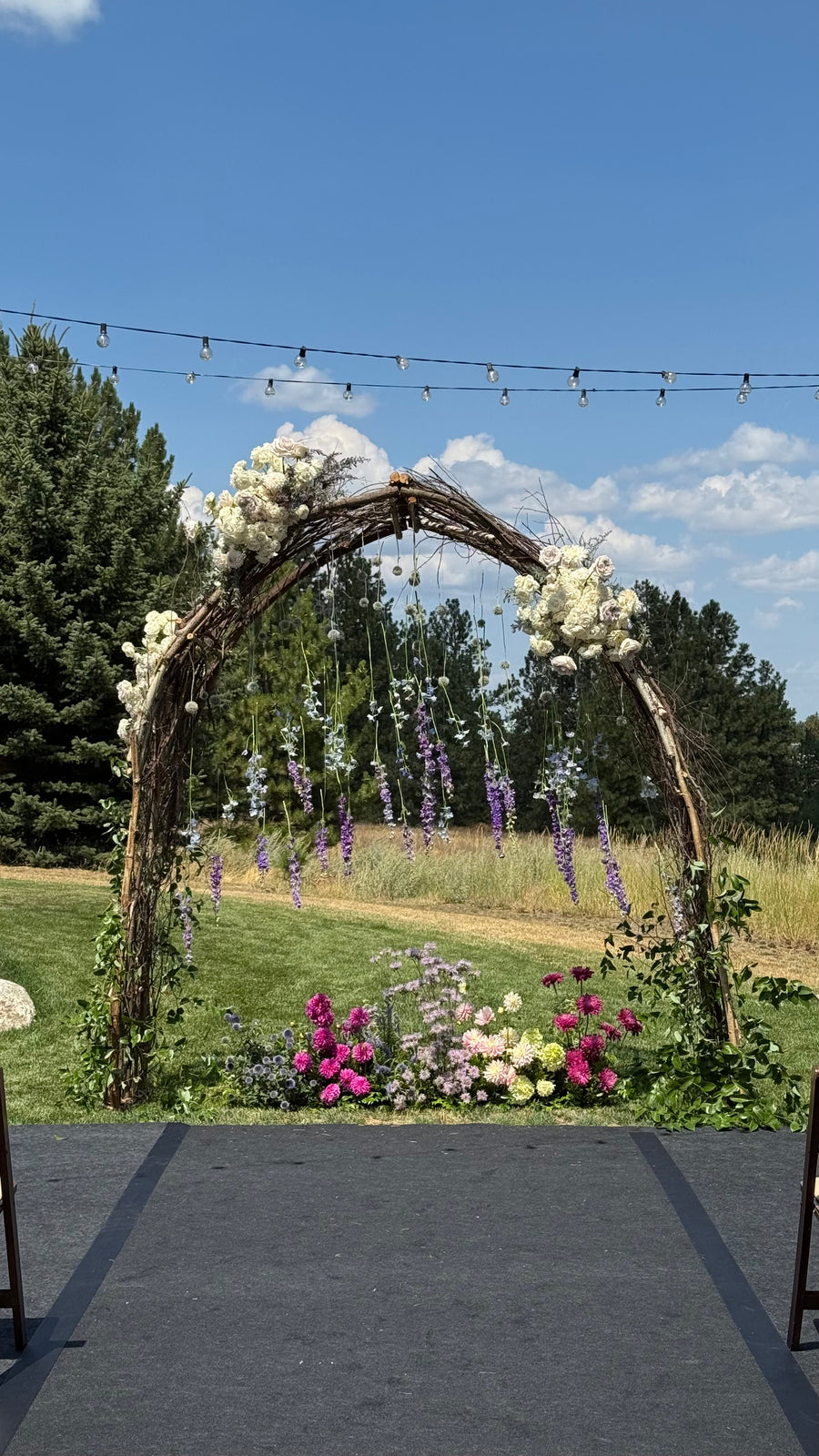 Delightful wedding arch with seasonal flowers by Daisies in May.